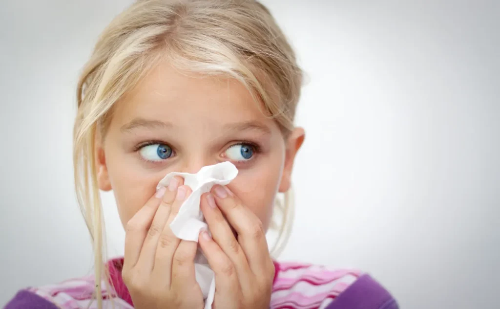 Girl with tissue and hay fever