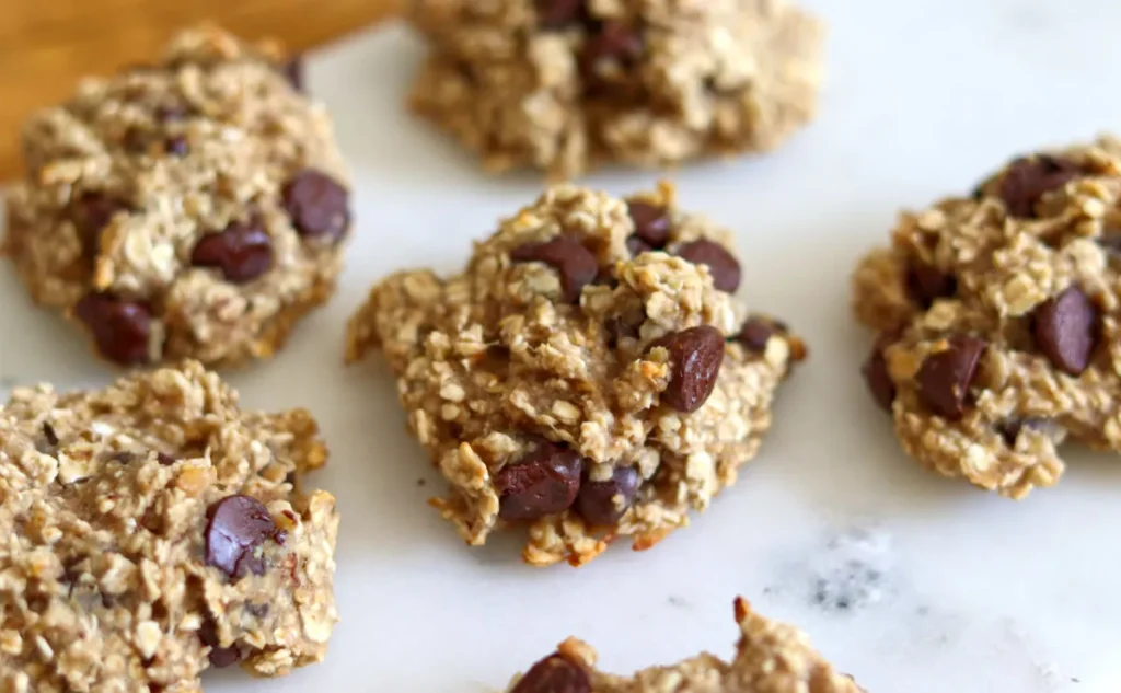 Homemade Banana and Chocolate Chip oat bites on white marble surface