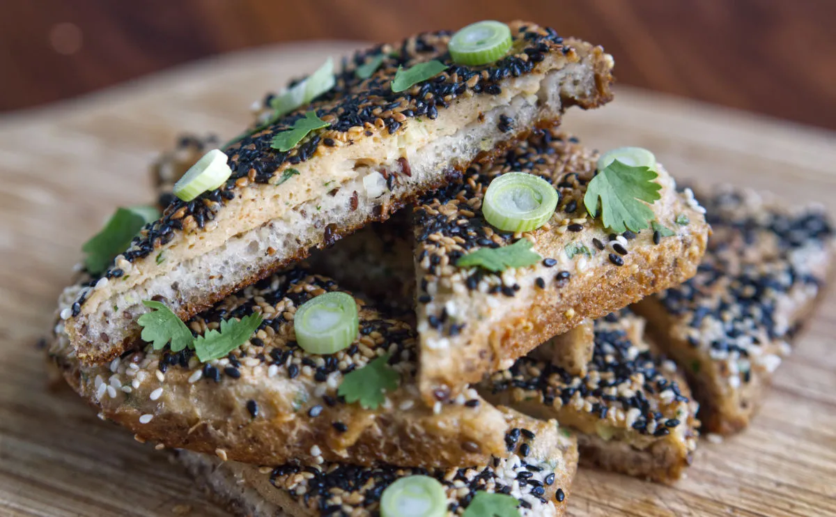 Sesame seed covered toasted prawn toasts. topped with spring onions