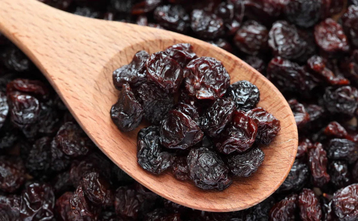 Raisins on a wooden spoon